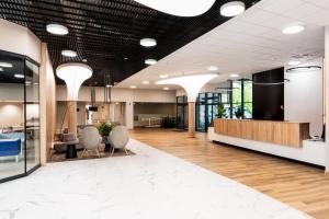 an office lobby with chairs and a reception desk at Interferie Dąbki SU Argentyt in Dąbki