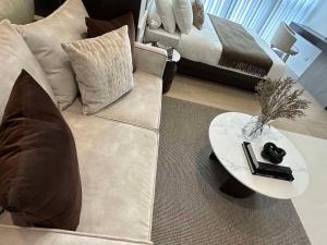 a living room with a couch and a table at Uptown Parksuites BGC in Manila