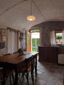 a dining room with a wooden table and chairs at Baita Borgo Incantato in Morbegno