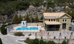 a villa with a swimming pool and a house at Sunrise Vista in Vasiliki