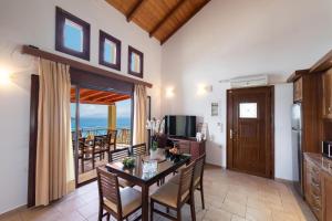 a kitchen and dining room with a table and chairs at Sunrise Vista by Vintage Travel in Vasiliki