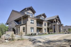 a large house on a dirt road at 101 Verbier - New 3BR Lux Condo w Mtn View Close to Everything in Mont-Tremblant