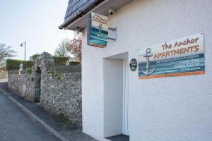 a sign on the side of a building with a wall at The Anchor Apartments in Ardglass