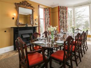 a dining room with a table and chairs and a mirror at Auchenvhin - Rockcliffe in Dalbeattie