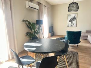 a living room with a black table and chairs at Vivianna’s guest house in Ermoupoli