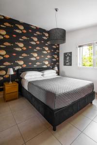a bedroom with a large bed with a colorful wall at Casa Mazzarini in Cesenatico +35 photos