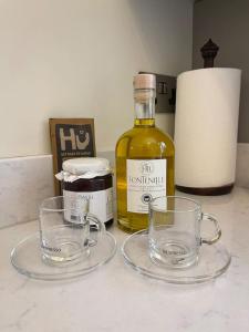 a bottle of whisky and two glasses on a counter at Luxury London English Charm in London