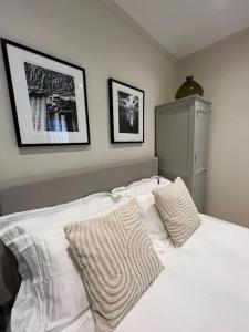 a white bed with two pillows on top of it at Luxury London English Charm in London