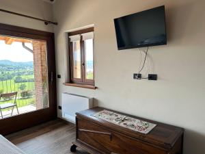 a living room with a flat screen tv on the wall at Cascina Coste in Roppolo