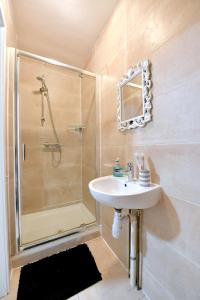 a bathroom with a sink and a shower at City Apartments near Seven Sisters in London