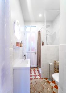 a white bathroom with a sink and a toilet at Villa Adèle, vue mer, sauna et plage in Mers-les-Bains