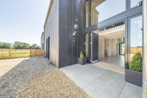 an external view of a house with a courtyard at The Grain Store in Reepham