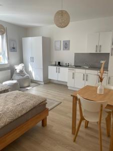 a living room with a table and a kitchen at Appartement Donauwelle 1 in Passau