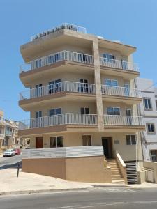 a tall building with white balconies and a street at Luxury Penthouse with private pool in Tas-Samra