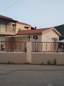 a house with a fence with a gate at Martha's House Kefalonia in Valsamáta