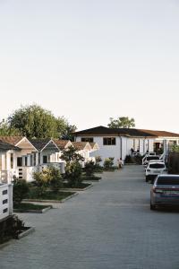 a row of houses with cars parked in a parking lot at Четыре Сезона in Novy Afon