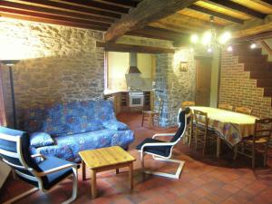 a living room with a couch and a table at Lovely Holiday Home in Treignes with Garden in Treignes