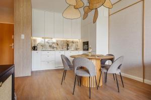 a dining room with a table and chairs at Baltica Residence - Premium Apartments in Gdańsk