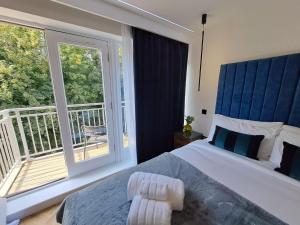 a bedroom with a large bed and a balcony at Newly Renovated Flat with Parking space in Canterbury