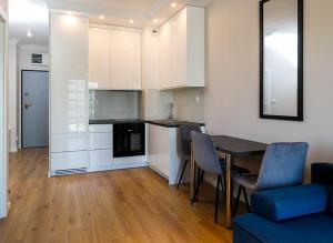a kitchen and dining room with a table and chairs at Apartament Bulwar Staromiejski Stare Miasto Centrum in Wrocław