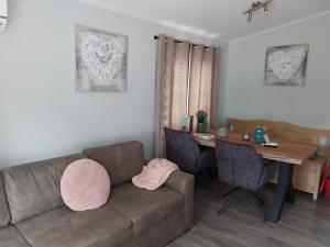a living room with a couch and a table at BPW 1105 - Bospark t Wolfsven in Mierlo