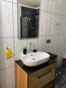 a bathroom with a white sink and a mirror at Ayazma home in Trabzon +27 photos