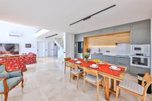 a kitchen and living room with a table and chairs at Luxury Sea View Villa w Pool Near Beach in Kalkan in Kalkan