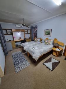 a bedroom with a bed and a table in it at Emani Guest House in Mokopane