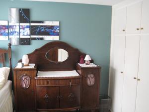 a childs bedroom with a wooden crib with a mirror at Central Reykjavík Apartment in Reykjavík