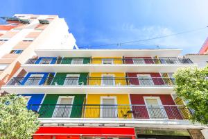 a building with colorful balconies on the side of it at Hostal El Mercat in Villajoyosa