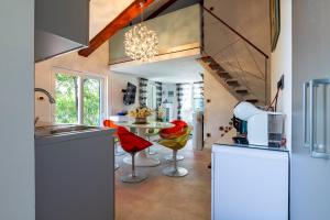 a kitchen with a sink and a table with chairs at Kuća za odmor Divna MaTi in Općina Trpanj