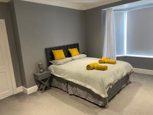 a bedroom with a bed with two stuffed animals on it at Seaside House-Next to the Beach, Sleeps 6 in South Shields