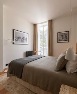 a bedroom with a large bed and a window at L'Appartement du Coin, Beaulieu-sur-Mer in Beaulieu-sur-Mer +31 photos