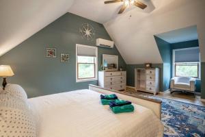 a bedroom with a white bed and a blue wall at Mountainview (Secluded Retreat) in Canandaigua