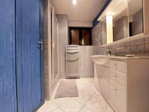 a bathroom with a sink and a refrigerator at Dépaysement à la campagne in Saint-Martin-de-Sanzay +16 photos