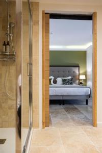 a master bedroom with a bed and a shower at Hôtel Des Gouverneurs in Bastia