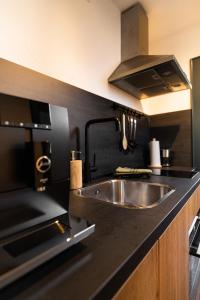 a kitchen with a sink and a stove at Mountainlodge Tirol Berwang in Berwang