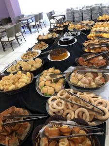 a table with many different types of food on it at Veredas do Rio Quente Flat in Rio Quente