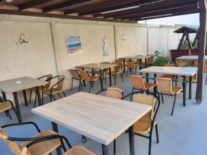 a row of tables and chairs in a restaurant at Casa Sagrada in Eforie Nord