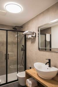 a bathroom with a sink and a shower at Baita Boniprati in Daone