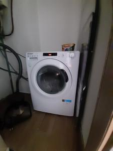 a washing machine in a corner of a room at Happy room in Karlovac