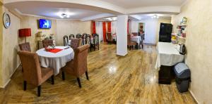 a dining room with a table and chairs at Noblesse House Deva in Deva