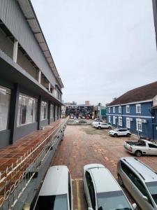 a parking lot with cars parked outside of a building at Lofts Visconde in Joinville