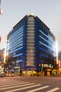 a large blue building on a city street at Green World Taipei Station in Taipei