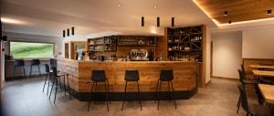 a bar in a restaurant with black stools at Baita Boniprati in Daone
