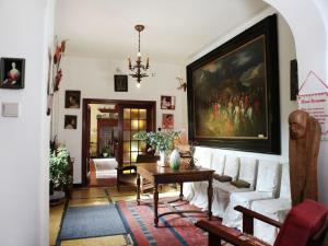 a living room with a painting on the wall at Comfortable Mansion in Doomkerke near Forest in Ruiselede