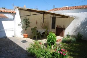 eine Terrasse mit einem Tisch und Stühlen in einem Haus in der Unterkunft Vaiana in Beauvoir-sur-Mer