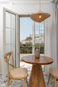 a table and chairs in a room with a balcony at Pension Sofi in Naxos Chora