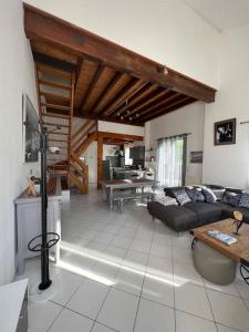 a living room with a couch and a table at La Petite Angérienne in Saint-Jean-dʼAngély