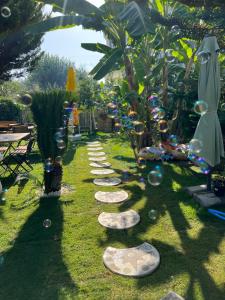 a row of stepping stones in the grass with a garden at Luna Alacati in Alacati